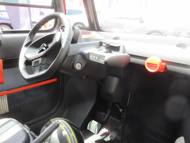 Spartan Citroën Ami interior with steering wheel, drive selector and hand-operated window